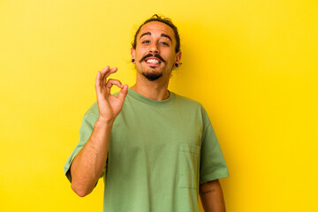Young caucasian man with long hair isolated on yellow background cheerful and confident showing ok...