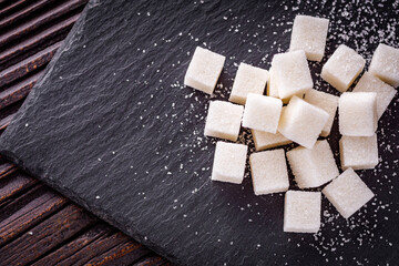 sugar refined on a dark stone background