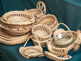 pile of handcrafted sweet grass baskets for sale