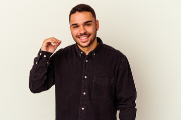 Young caucasian man isolated on white background laughing about something, covering mouth with hands.