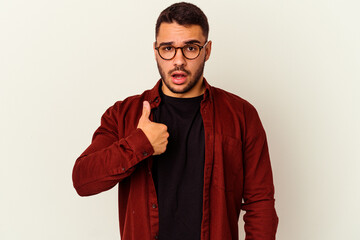 Young caucasian man isolated on white background surprised pointing with finger, smiling broadly.