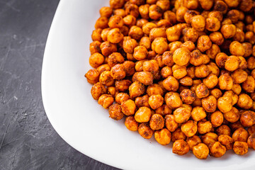 fried chickpeas on a dark stone background