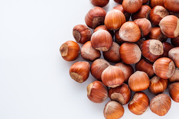 fresh natural hazelnuts on a white acrylic background