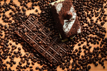 Chocolate with coffee beans and truffle cake, delicious sweet dessert for coffee or tea. Chocolate and caffeine addiction. Unhealthy eating.
