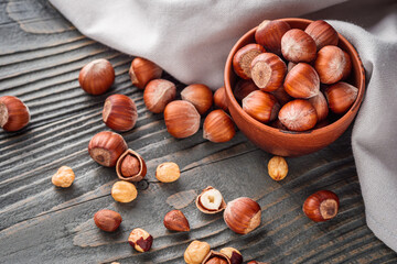 fresh natural hazelnuts on a dark wooden rustic background