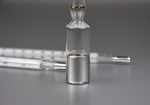 Mercury chemical element stock images. Laboratory accessories images. Mercury in a sealed ampoule stock photo. Laboratory equipment on a silver background. Hg, toxic chemical element stock images