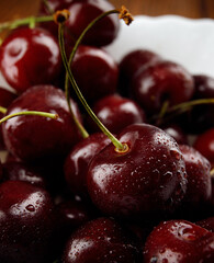 Ripe cherries background.Ripe juicy petioles on a white background.