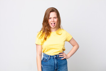 pretty red head woman feeling disgusted and irritated and tongue out