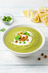 Green pea split soup on wooden background. Copy space.