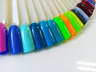 Different colorful nails polish manicure palette Background. Samples of nail varnishes. False...