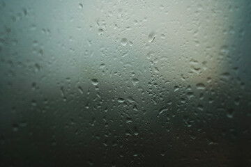 Close-up of window with raindrops background cloudy sky. Concept. Beautiful rain background with raindrops on glass. Raindrops on window run down. High quality photo