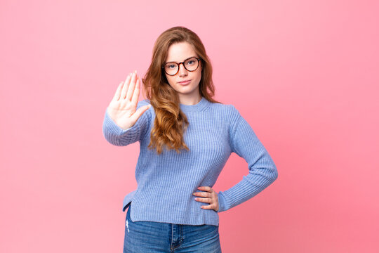 Pretty Red Head Woman Looking Serious Showing Open Palm Making Stop Gesture