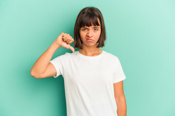 Young mixed race woman isolated on blue showing thumb down, disappointment concept.