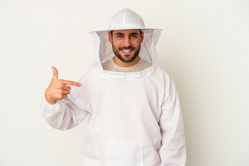 Young apiculture caucasian man isolated on white background person pointing by hand to a shirt copy space, proud and confident