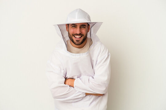 Young apiculture caucasian man isolated on white background laughing and having fun.