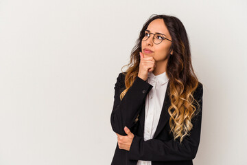 Young mexican business woman isolated on white background looking sideways with doubtful and skeptical expression.