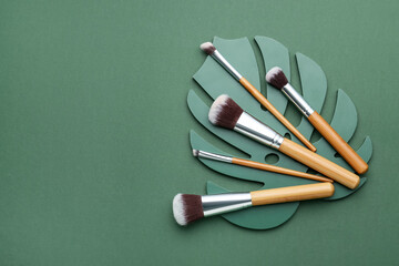 Set of makeup brushes on color background