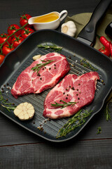 Fresh raw beef or pork steaks on frying pan