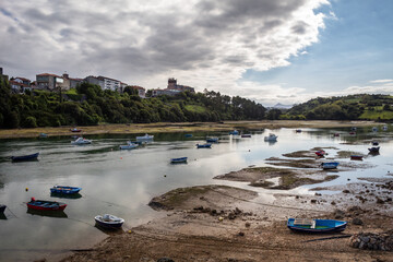 Fishing boats stay on land when the tide is low in the estuary.