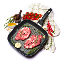Fresh raw beef or pork steaks on frying pan