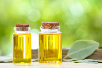 Bottles of essential oil on table outdoors, closeup