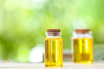 Bottles of essential oil on table outdoors, closeup