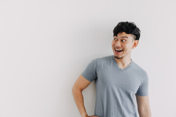 Happy face of Asian man look at an empty space isolated on white background.