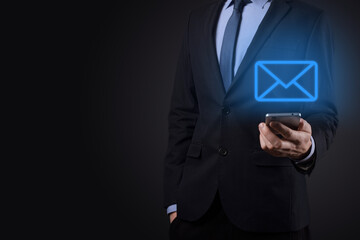 Businessman hand holding e-mail icon, Contact us by newsletter email and protect your personal information from spam mail. Customer service call center contact us concept
