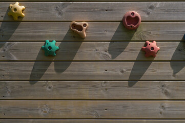 coloured shapes fixed to a wooden background