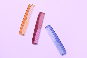 Different hair combs on color background