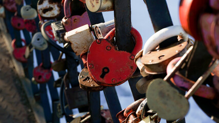 Fototapeta na wymiar Love Padlocks Lockers at the bridge in Russia. People have place padlocks on the fence symbolizes forever love.