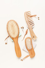 Hair brushes and comb on color background