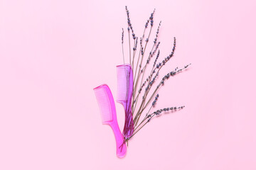 Hair combs and flowers on color background