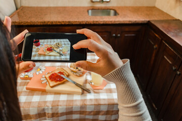point of view of a hispanic woman taking a picture of her breakfast