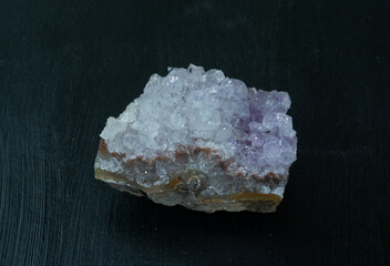 Amethyst violet variety of quartz from Brazil. Natural mineral stone on black background....
