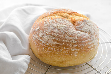 Loaf of sourdough bread on light background