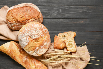 Fresh bread on dark wooden background