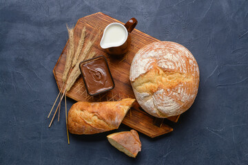 Composition with fresh bread on dark background