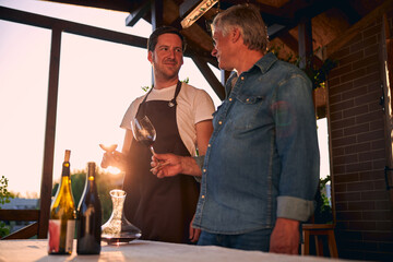 Skilled sommeliers on the terrace of their winery