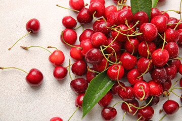 Fototapeta na wymiar Heap of tasty ripe cherry on light background