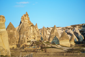 View of the ancient rocks houses in the valley during the sunset in Cappadocia, Turkey