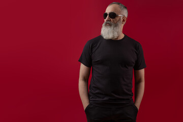 Adult handsome senior male model with a gray beard wearing a black t-shirt