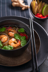 Asian soup with noodles, shrimps,coriander,ginger,chili.Traditional asian food..