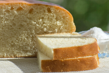 Slices of fresh homemade bread on the table. Simple traditional food. Side view.