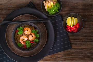 Fototapeta na wymiar Asian soup with noodles, shrimps,coriander,ginger,chili.Traditional asian food..