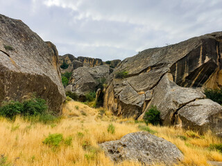 Gobustan national park ancient rocks, rock path and mountains near Baku in Azerbaijan. Exposition of Petroglyphs in Gobustan near Baku, Azerbaijan.