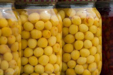 The fruits and berries were preserved. Delicious yellow cherry in the glass jars. Homemade preservation.