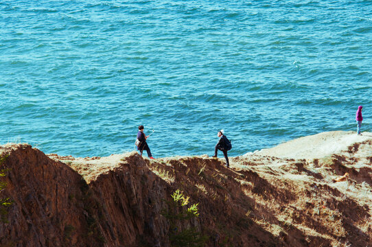 tourists are photographed on a trip to the seaside rocks