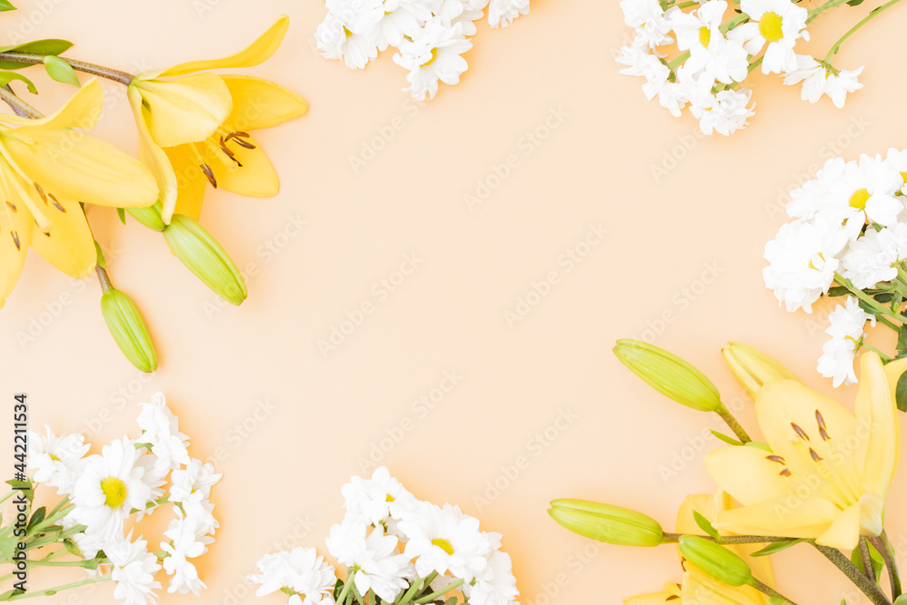 Wall mural flat lay frame with yellow lilies on color background