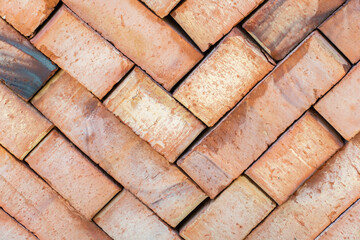 Lot of red ceramic bricks backdrop at construction, building site